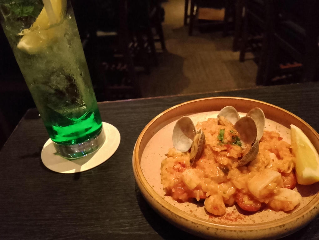 Photo of my table. Pescatore-style risotto on the right, ENcore drink on the left